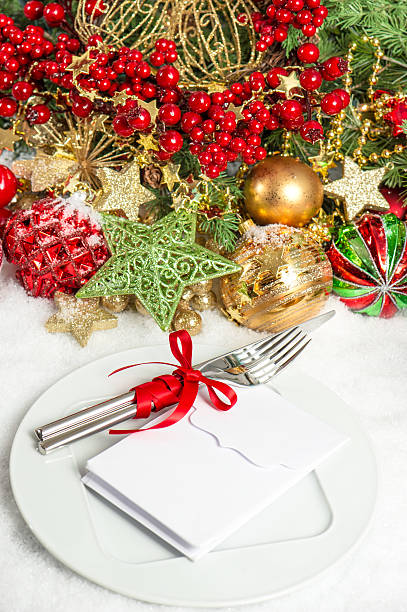 istock Table setting decoration with red baubles golden garlands 491148524