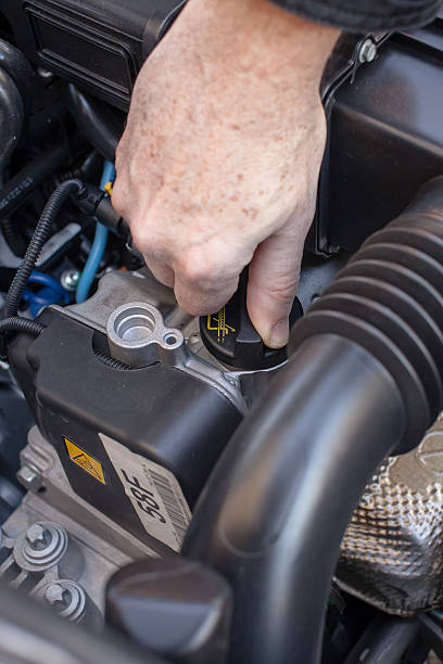 istock Hand that controls the oil cap in a car engine 491149306