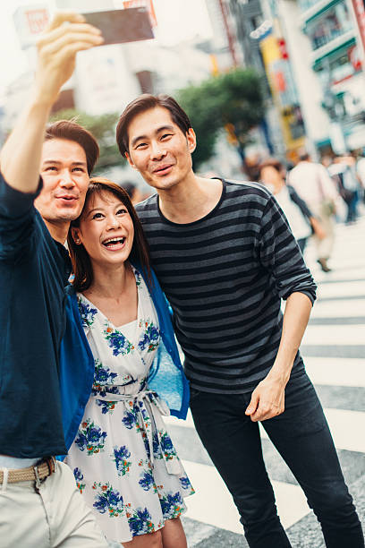 istock Happy japanese friends making a selfie 491167650