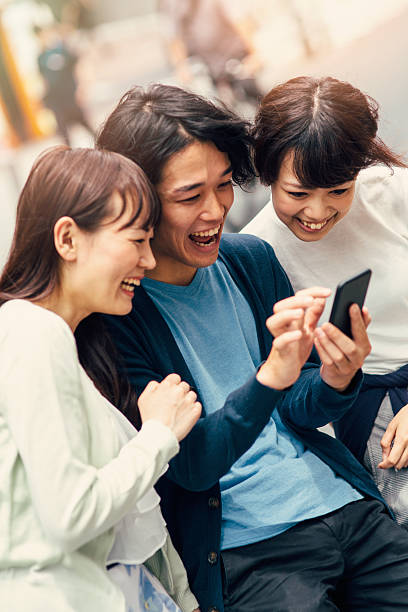 istock Happy japanese friends surfing the net 491167674