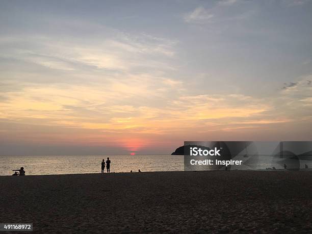 Kata Beach Sunset With Tourists Stock Photo - Download Image Now - 2015, Aquamarine, Asia