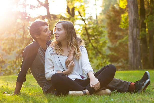 istock Young people smiling at eachother in the park 491169168