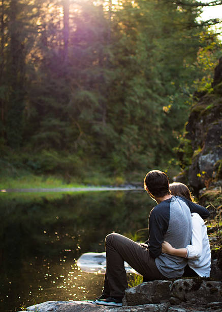 istock Young people enjoying the sunset by the river 491169226