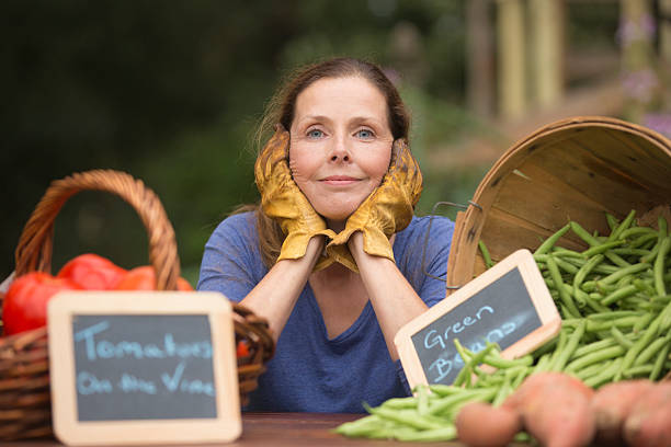 Woman taking a break from her vegetable stand