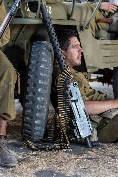 Exhausted WWII Army Solders Resting next to their Jeep stock photo