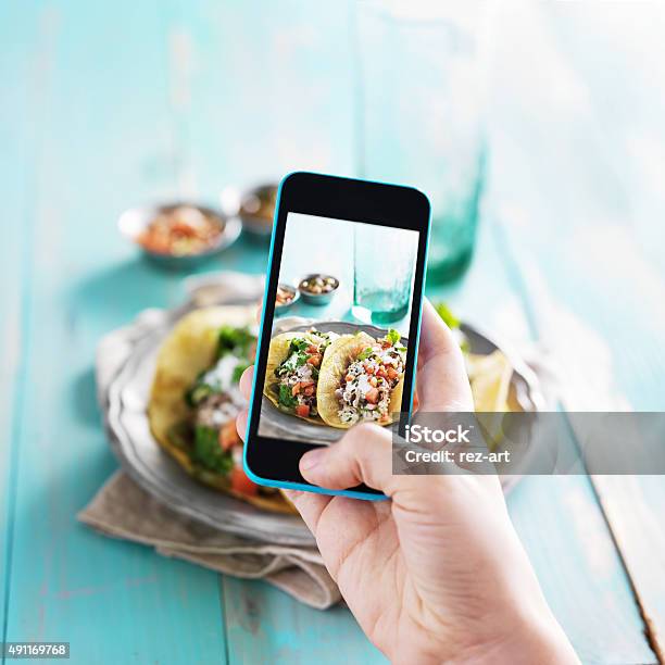 Taking Photo Of Carnitas Street Tacos With Smart Phone Stock Photo - Download Image Now