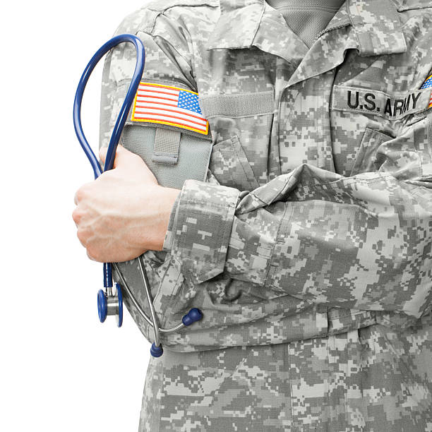 US Army doctor holding stethoscope - studio shot stock photo