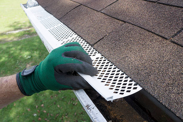 Contractor Adjusting Plastic Gutter Guards Contractor adjusting plastic gutter guards to get them to fit. roof gutter photos stock pictures, royalty-free photos & images