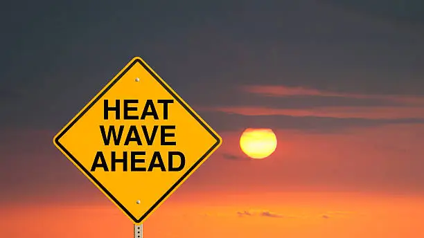 A sign that "Heat Wave Ahead."