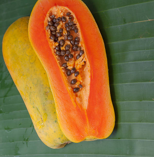 istock Cut papaya on a green background. 491173602