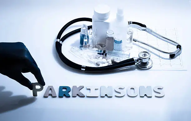 Diagnosis - Parkinsons. Medical concept with pills, injection, stethoscope, cardiogram and a syringe