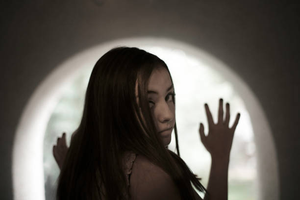 istock Young girl looking out window 491186452