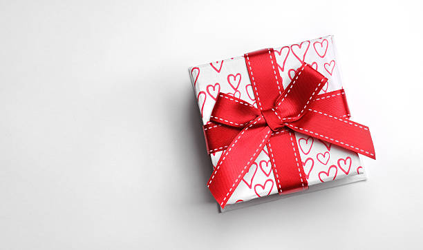 istock White gift box with bow and painted hearts isolated top 491203892