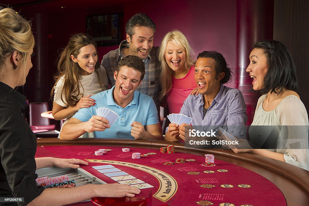 Group Of Friends Playing Blackjack In Casino 20-24 Years Stock Photo