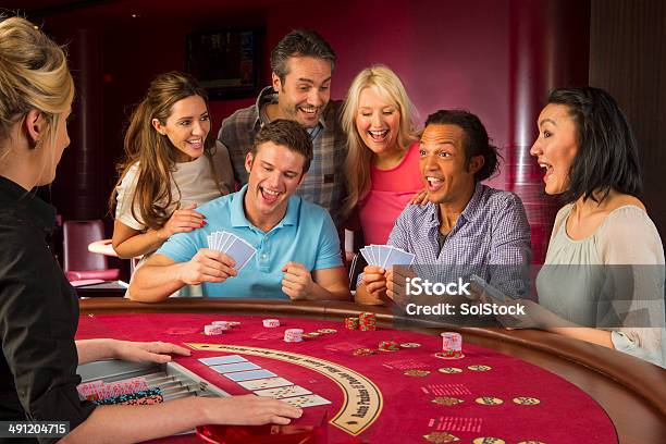 Group Of Friends Playing Blackjack In Casino Stock Photo - Download Image Now - 20-24 Years, 25-29 Years, 30-34 Years