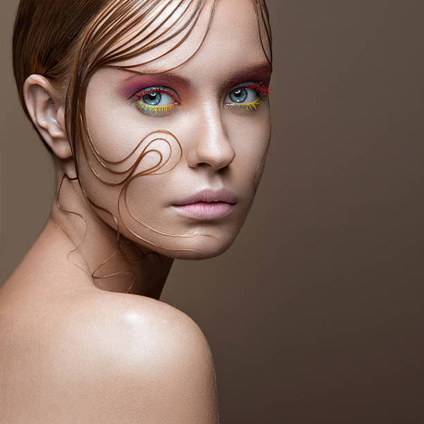 istock Beautiful girl with bright colored makeup and wet strands of 491206614