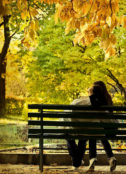 istock Romantic couple sitting in the autumn park 491207491