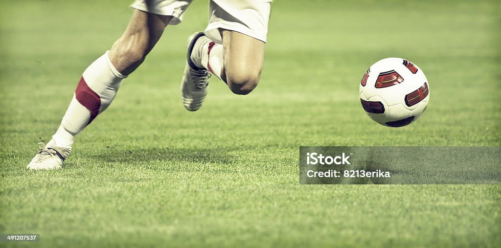 Football player Soccer player running after the ball Soccer Stock Photo