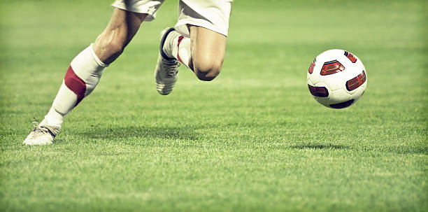 Football player Soccer player running after the ball human foot photos stock pictures, royalty-free photos & images