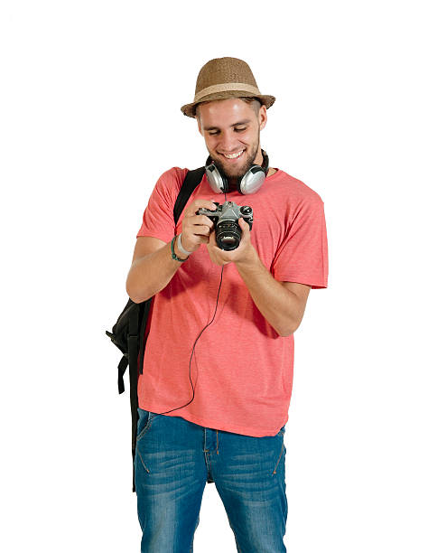 Young handsome tourist traveling with camera and backpack
