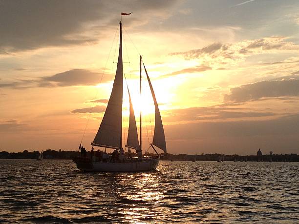 Schooner at Sunset Schooner silhouette at sunset in the harbor at Annapolis, Maryland, USA, on the Chesapeake Bay. skipjack stock pictures, royalty-free photos & images