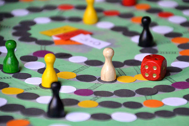family game evening with self made board-game self made board-game with tokens and dice token photos stock pictures, royalty-free photos & images