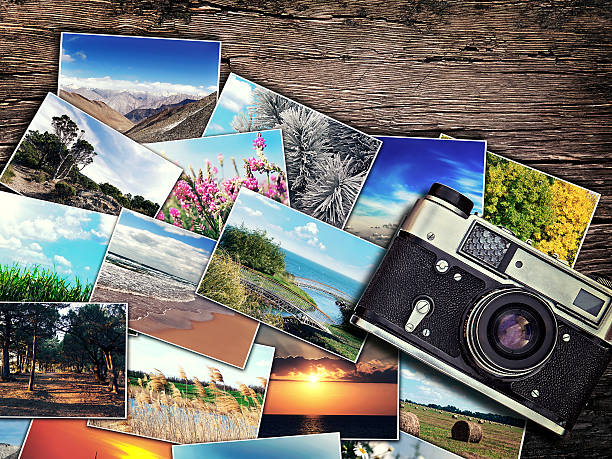 istock old vintage camera and photos on a wooden background 491220180