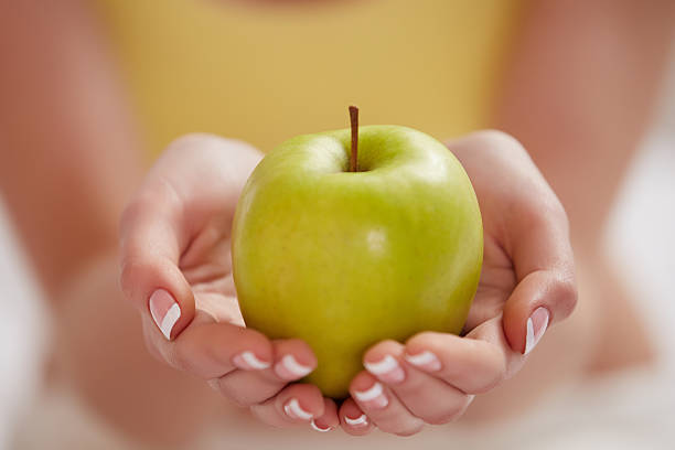 istock Green Apple In Woman Hands 491221558