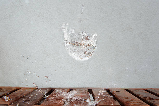 istock Imaginary water glass splash on wooden desk 491221892