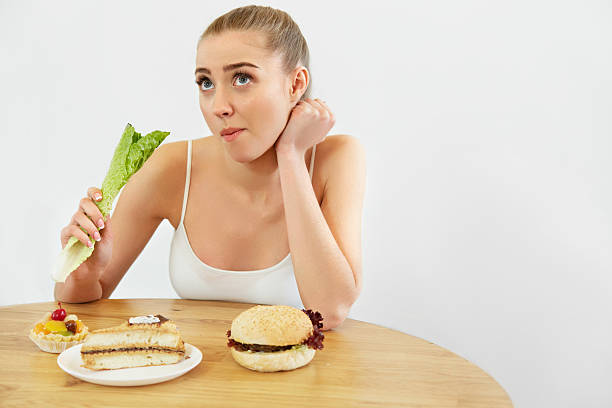 istock Diet concept.  Beautiful Young Woman eats Lettuce 491222354