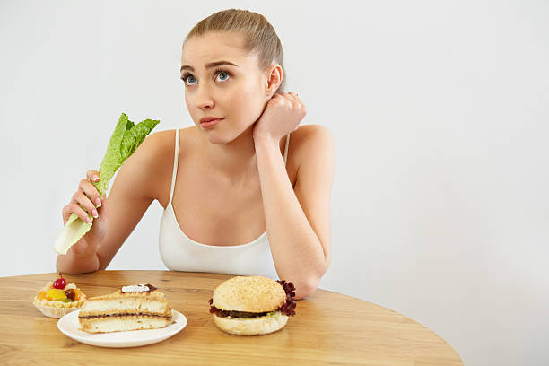 istock Diet concept.  Beautiful Young Woman eats Lettuce 491222394