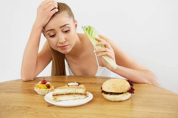 istock Diet concept.  Beautiful Young Woman eats Lettuce 491222444