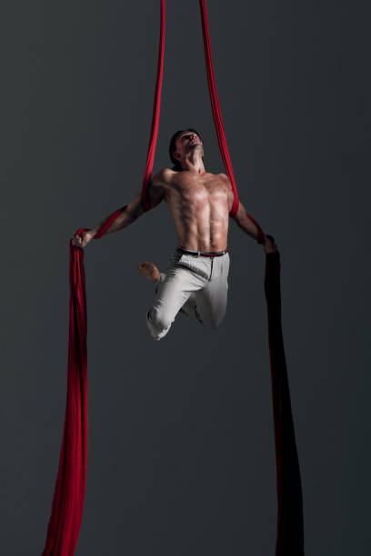 istock Man performing aerial silk dance 491223494