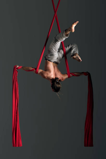 istock Man performing aerial silk dance 491223546