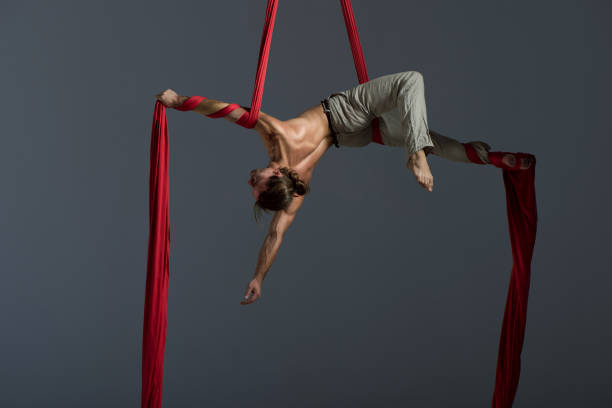 Man performing aerial silk dance