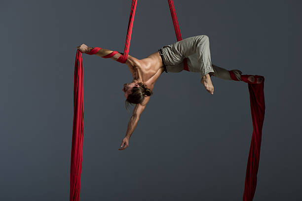 Man performing aerial silk dance stock photo
