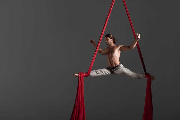 istock Man performing aerial silk dance 491224326