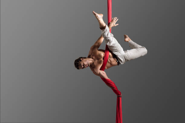 Man performing aerial silk dance stock photo