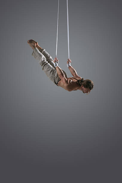 istock Man performing aerial silk straps 491230124