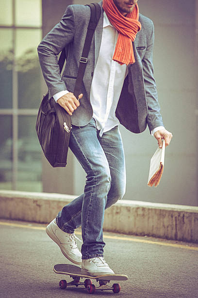 istock Young casual businessman commuting to work skateboarding. 491231386