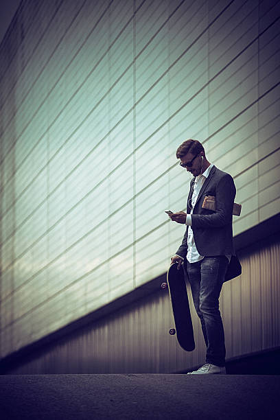 istock Young casual businessman using smartphone in the urban environment 491231614