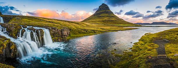 istock Idyllic waterfall sunrise cloudscape beside mountain peak panorama Kirkjufell Iceland 491232062