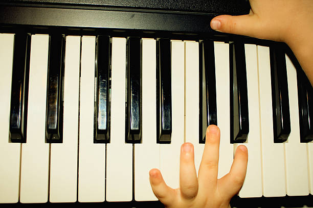istock hands of kid who playing piano 491232648