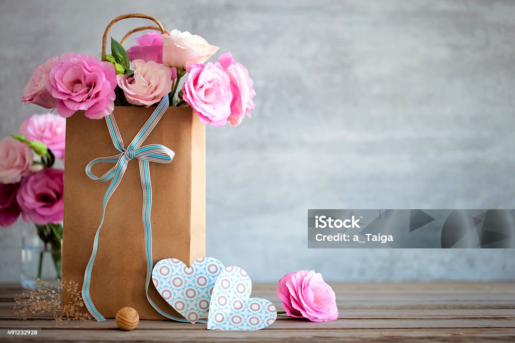 Love background with roses flowers and bow Love background with pink roses flowers, bow and paper handmade hearts 2015 Stock Photo