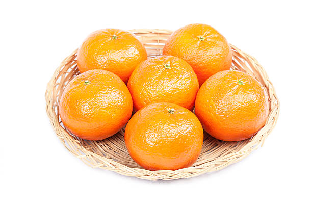 istock Tangerines in a wicker plate on a white background. 491233228