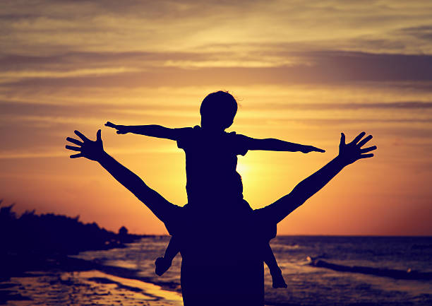 istock father and son having fun at sunset 491233716