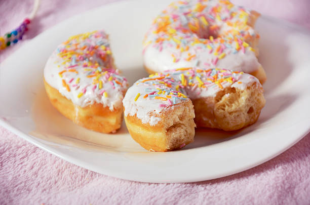 istock half-eaten donuts on the plate close-up pink color 491233776