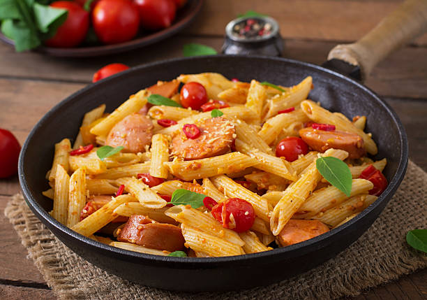istock Penne pasta with tomatoes and sausage 491236274