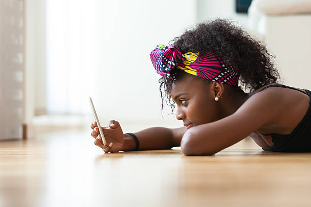 istock African woman sending a text message on a mobile phone 491236644
