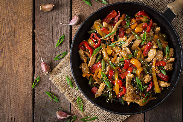 Stir fry chicken, sweet peppers and green beans stock photo